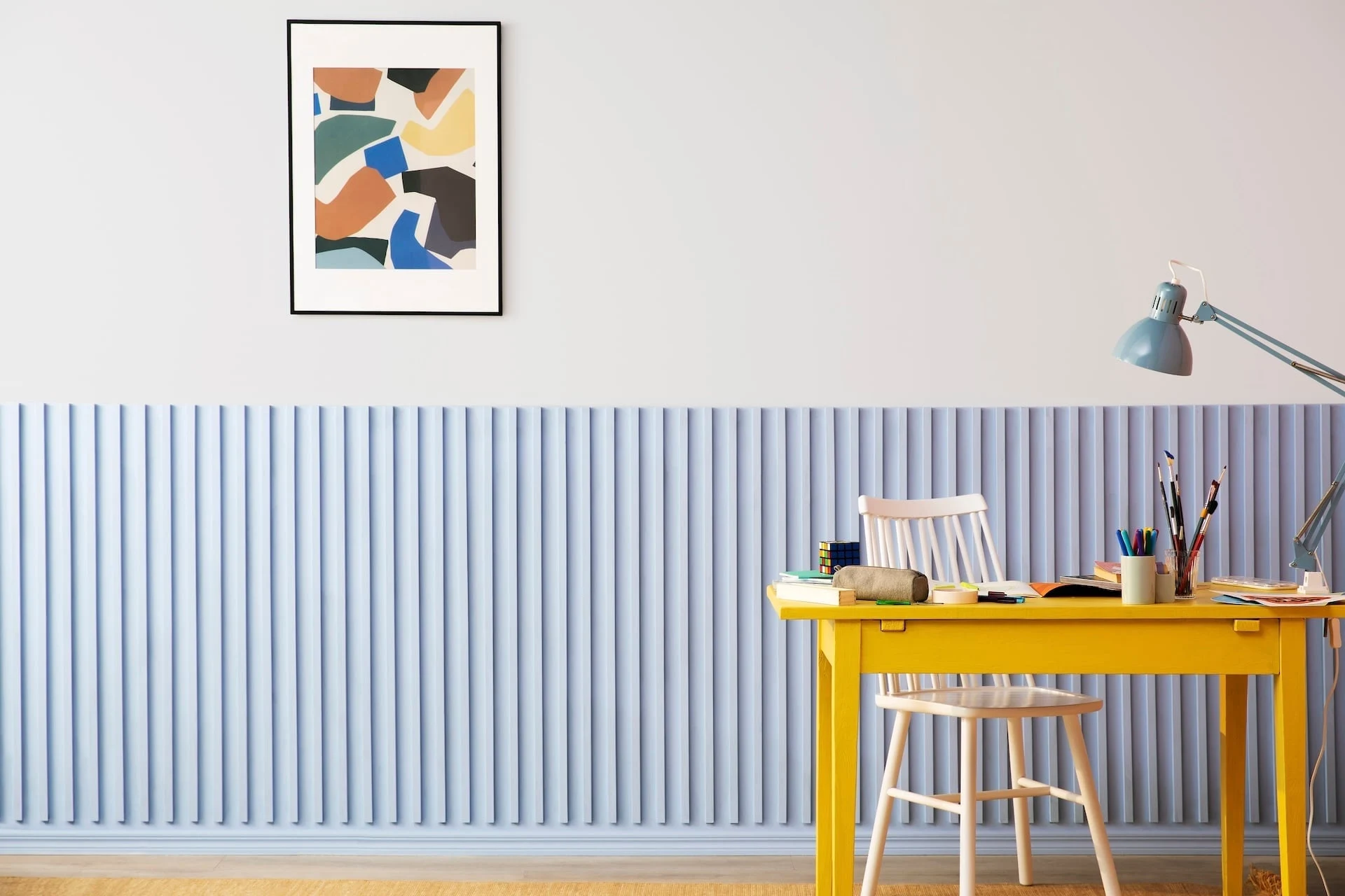 Blue painted kids room with a desk